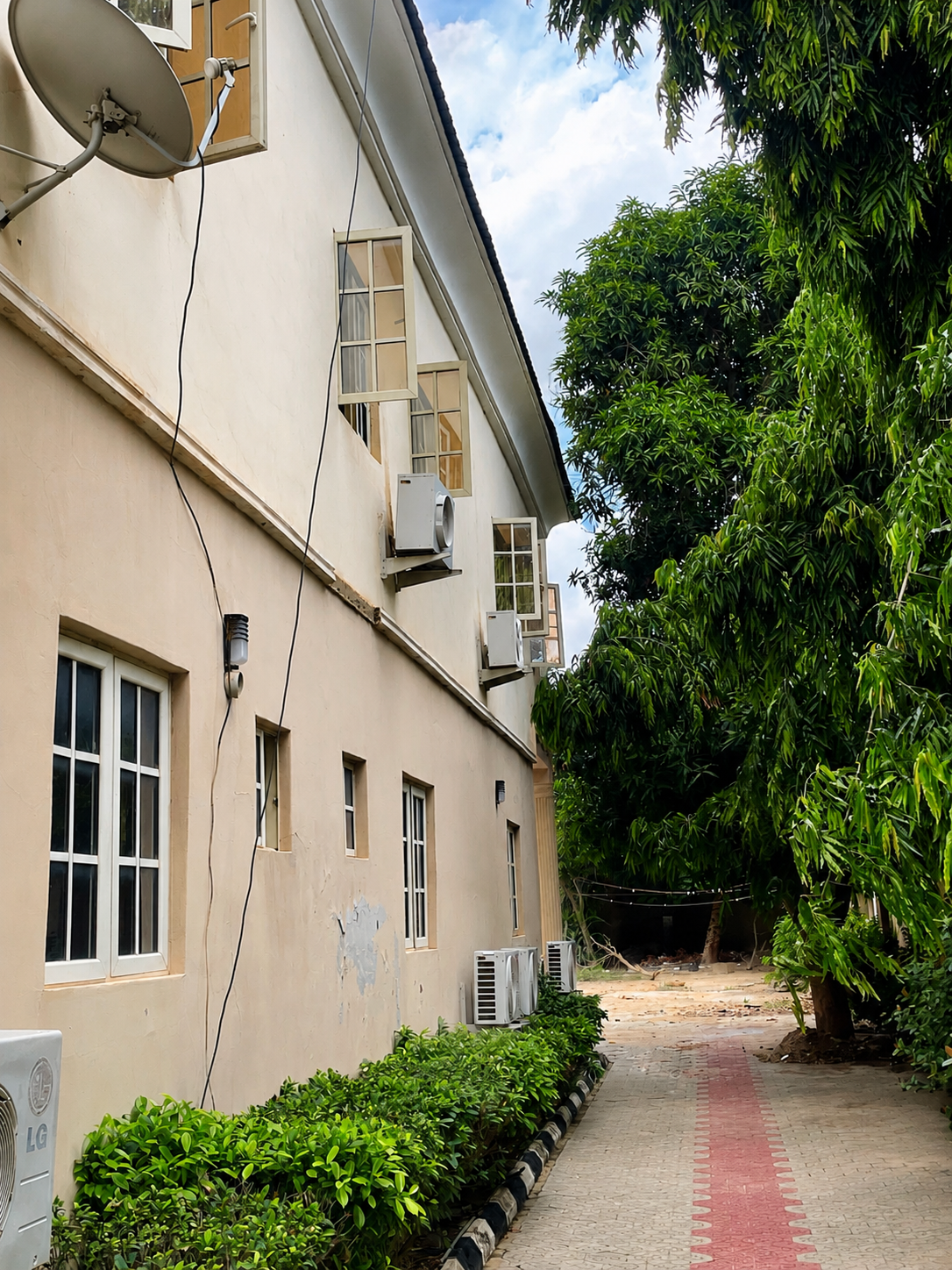 MHWUN office environment with trees and shaded parking area