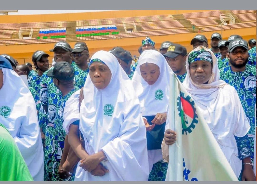 Health workers holding a banner at a May Day event