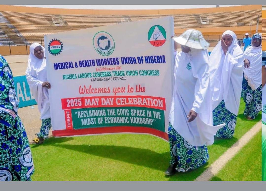Workers carrying a May Day celebration banner