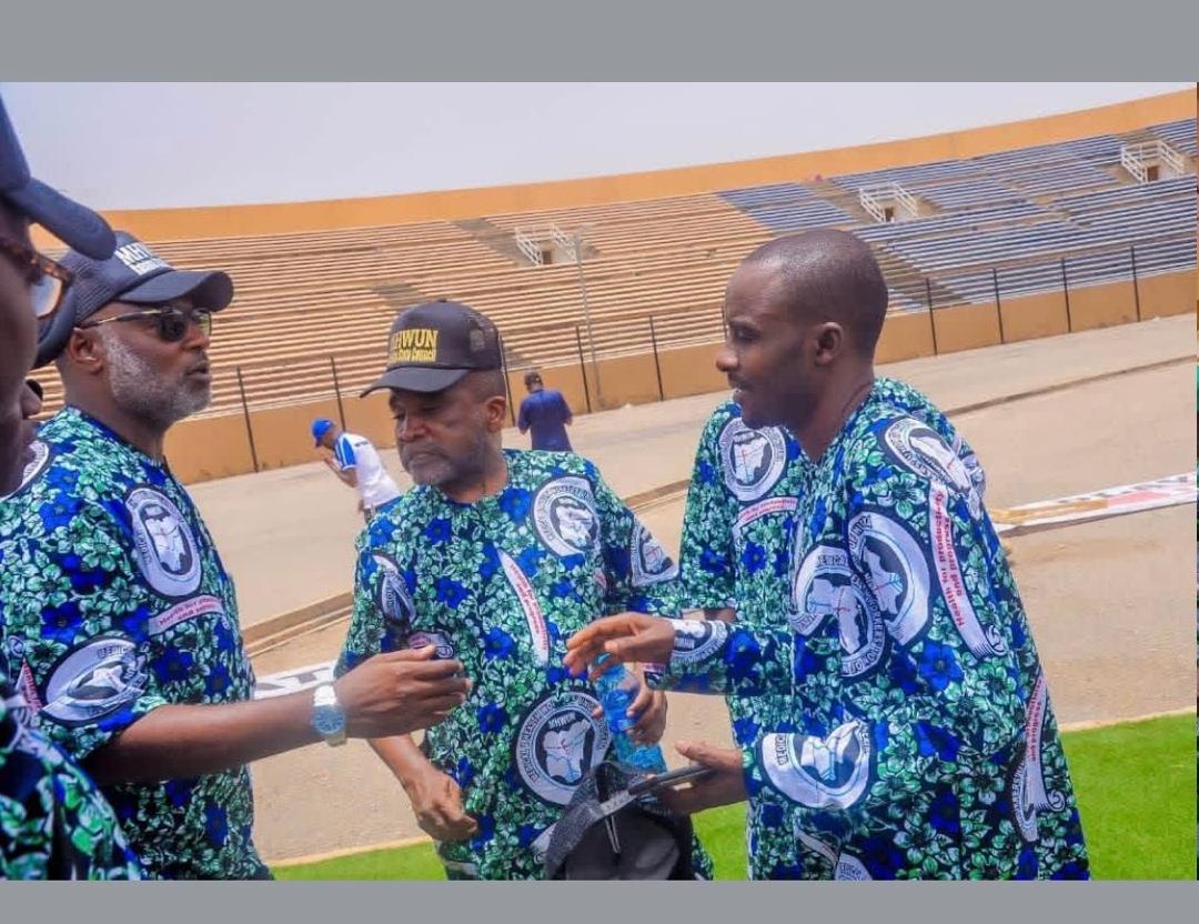 Union officials in a field discussion at a stadium