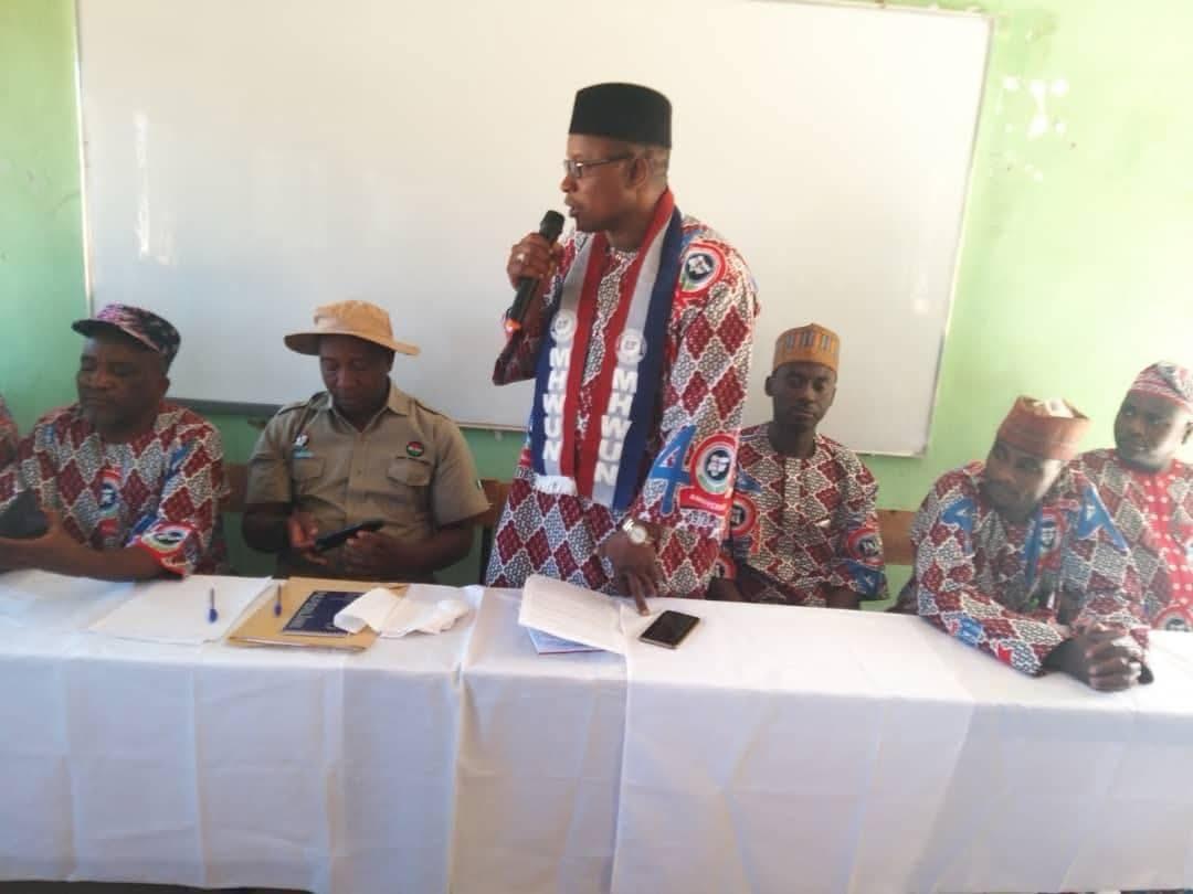 MHWUN family members standing and raising hands